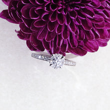 Load image into Gallery viewer, image: The My Diamond Philippines Claw Prong Milgrain Ring with Pave-Set Side Stones is crafted in 14K white gold that features a 0.22-carat diamond and 28 pieces of 0.32-carat diamond side stones with a clarity grading of VS-SI1 and a combination of colors F-G for gifts with flower
